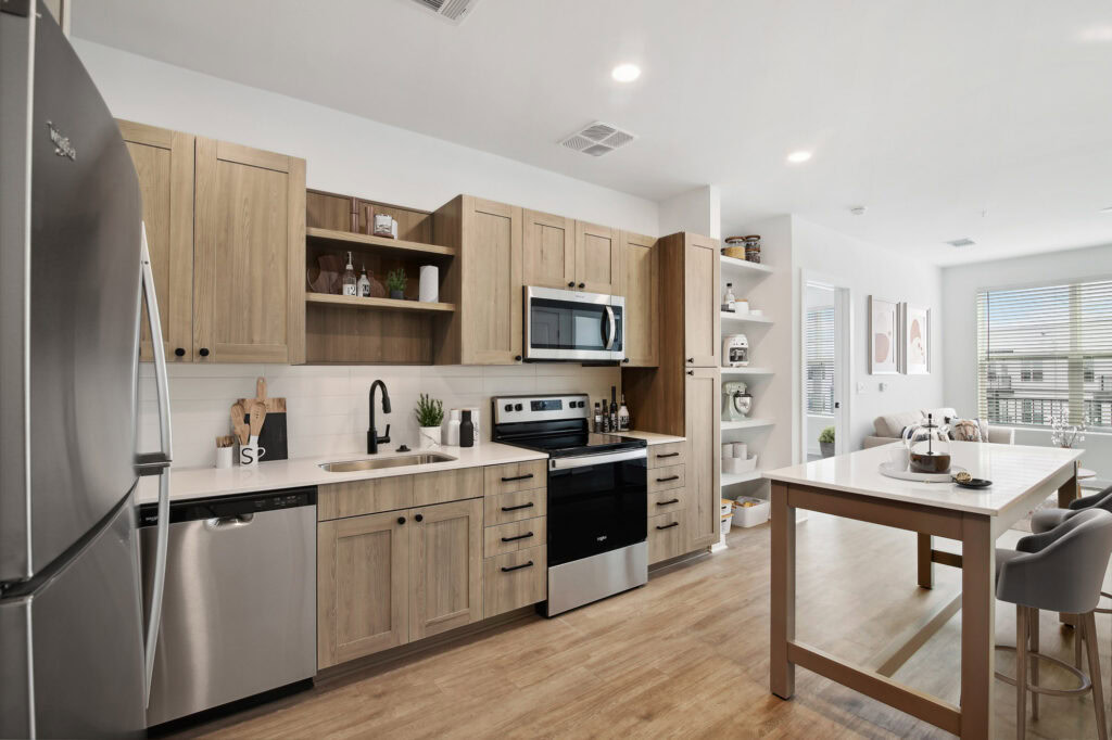 A kitchen with a kitchen island in a Tallulah apartment in Cumberland, GA