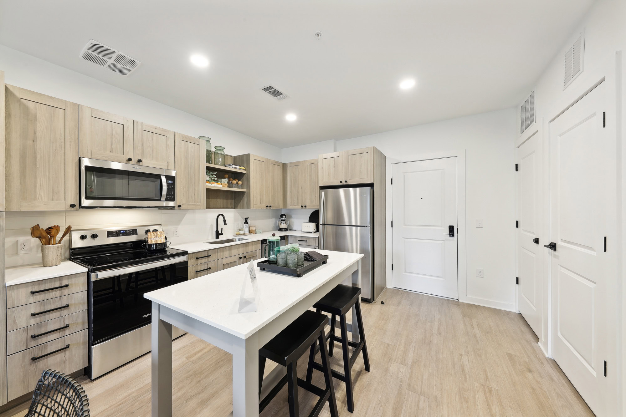 A kitchen with a kitchen island in a Tallulah apartment in Cumberland, GA