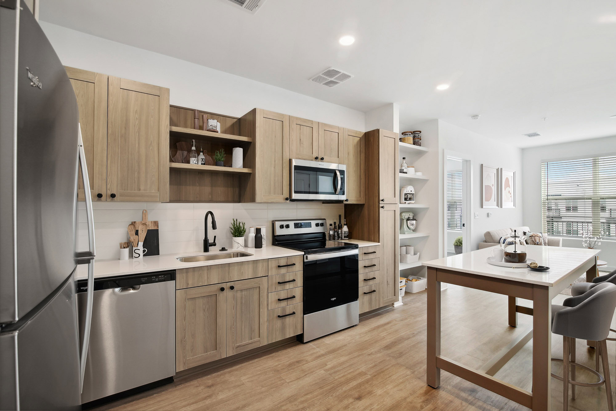 A kitchen with a kitchen island in a Tallulah apartment in Cumberland, GA