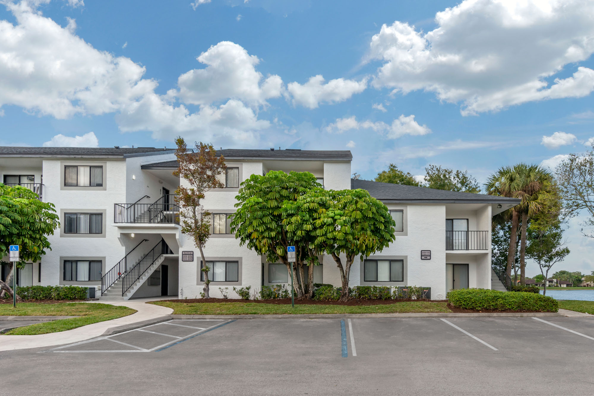 The exterior of apartments and parking spaces at The Reserve at Ashley Lake.