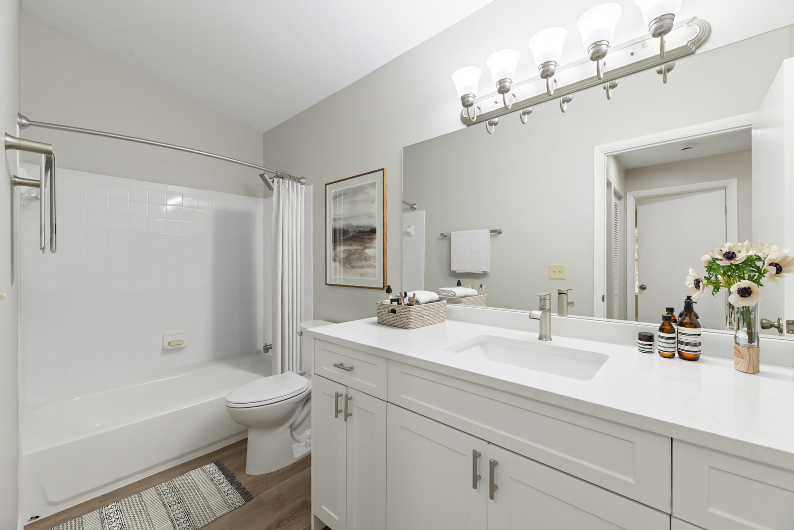 A bathroom with a tub and showerhead in a West Palm Beach apartment at Turtle Cove