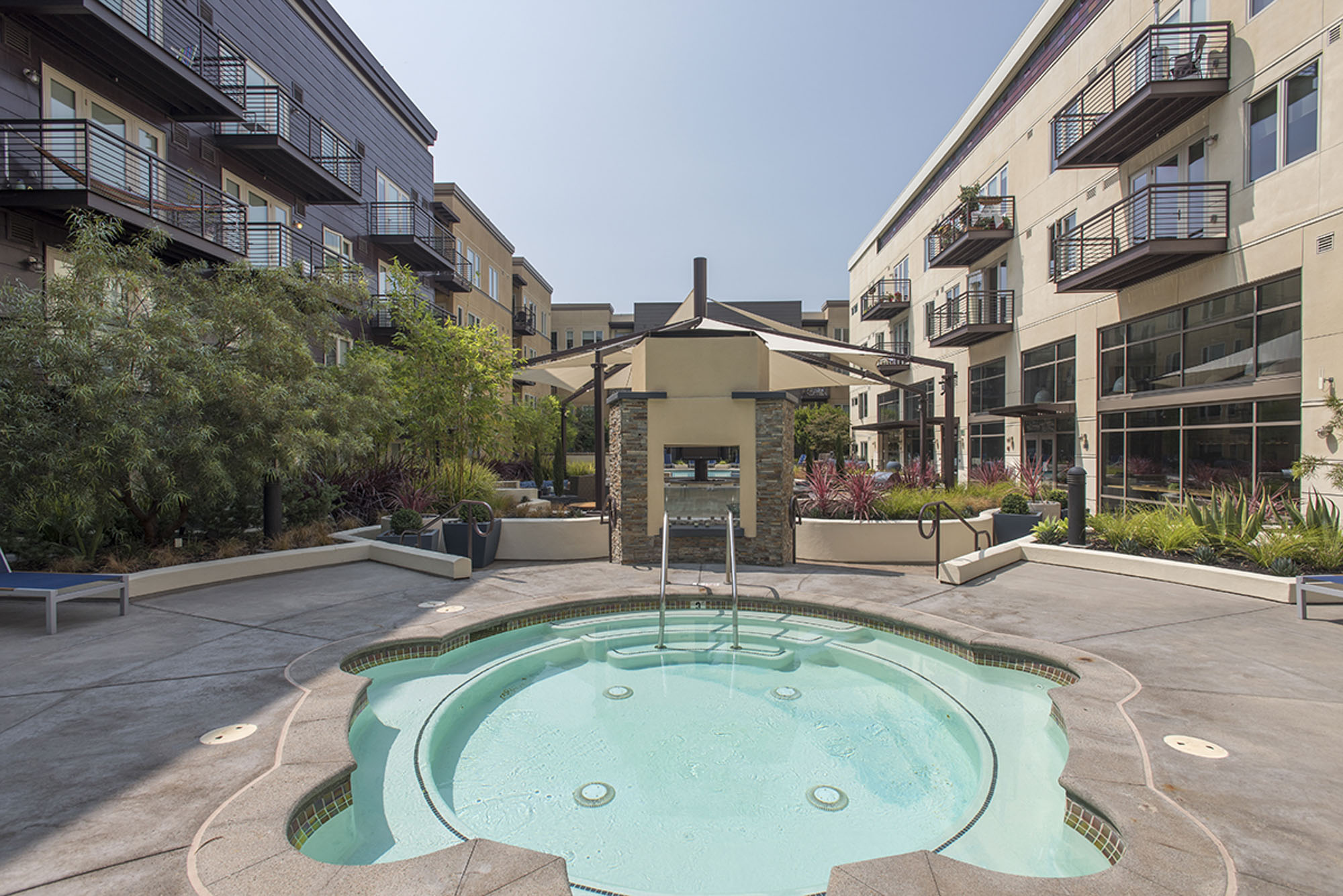 A circular hot tub at the pool courtyard of Mountain Views new apartments, The Village Residences