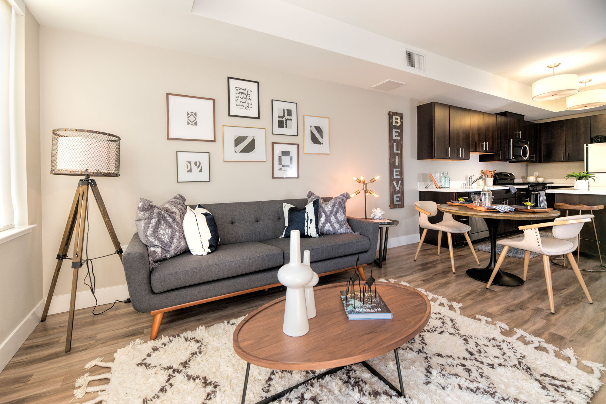 An open plan living room leading to a dining area and kitchen at The Village Residences new apartments in Mountain View, CA