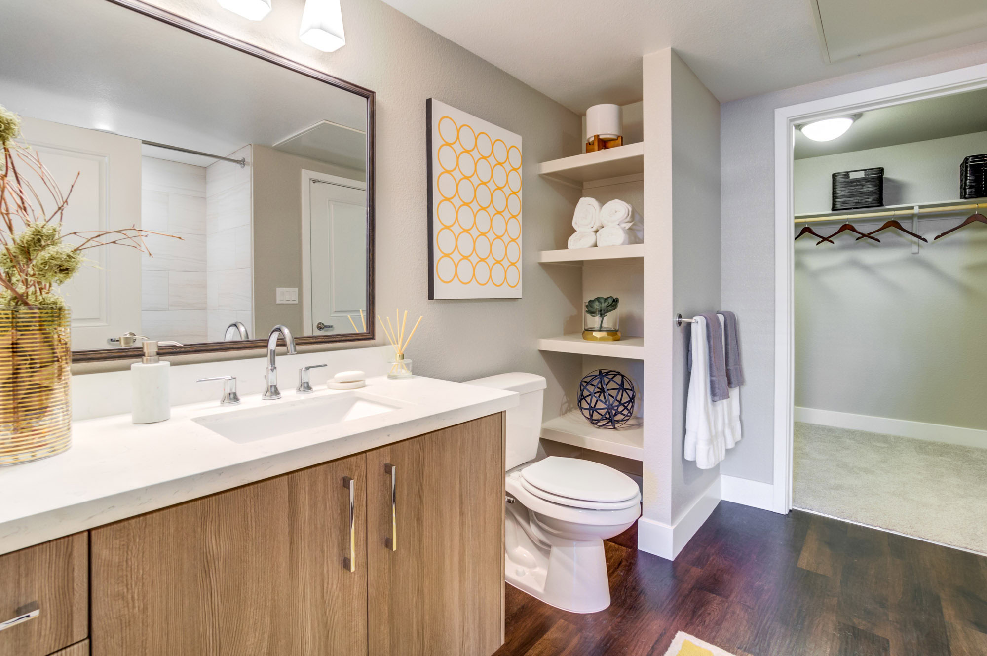 An ensuite bathroom with a carpeted walk in closet at the Vintage apartments in Pleasanton, CA