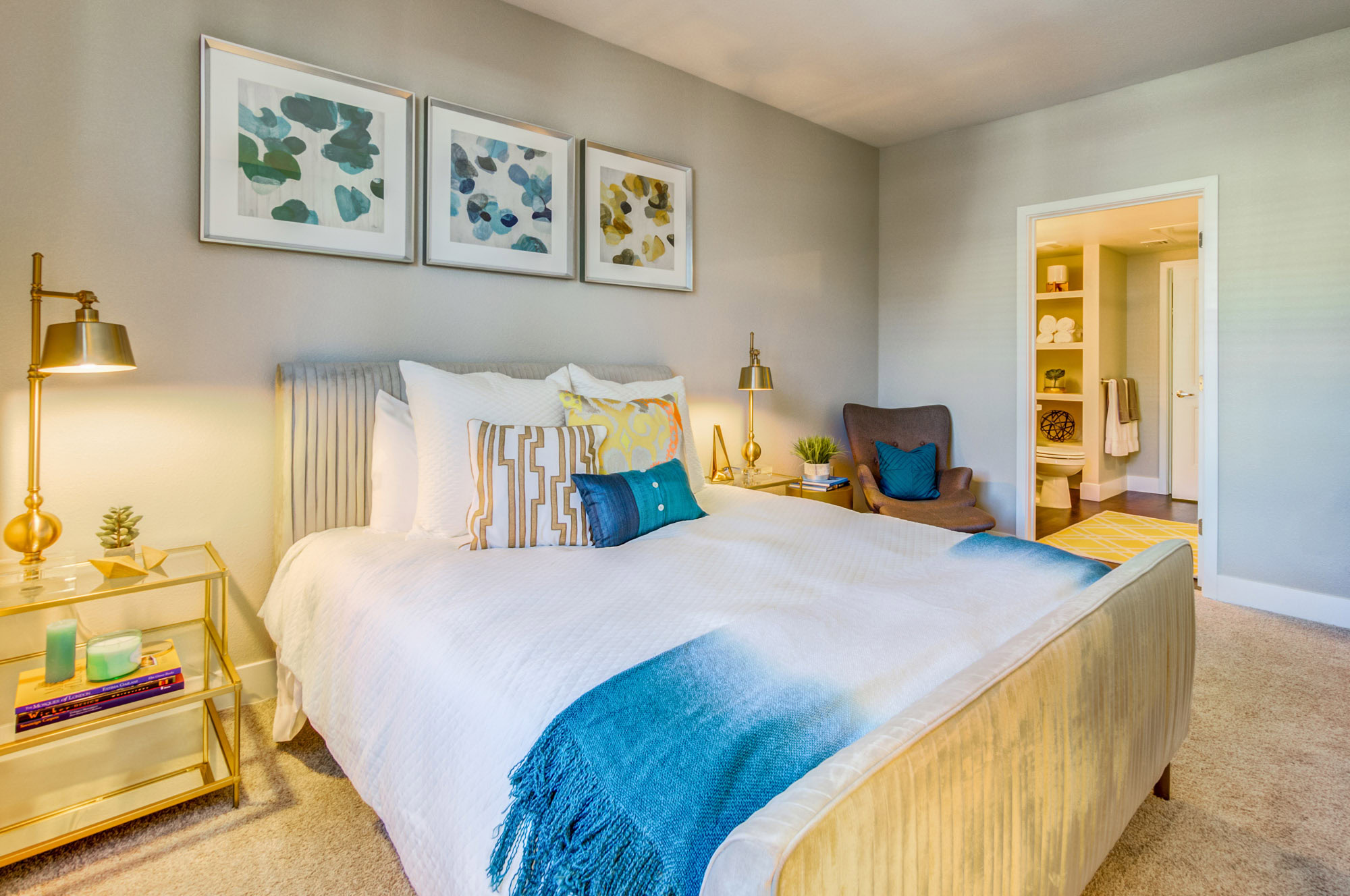 An ensuite bedroom with carpet flooring in an apartment at the Vintage apartments in Pleasanton, CA