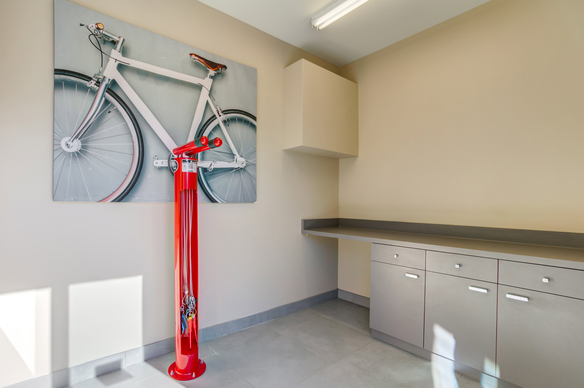 A bike station with pump, cupboard storage and a long counter at Vintage apartments in Pleasanton, CA