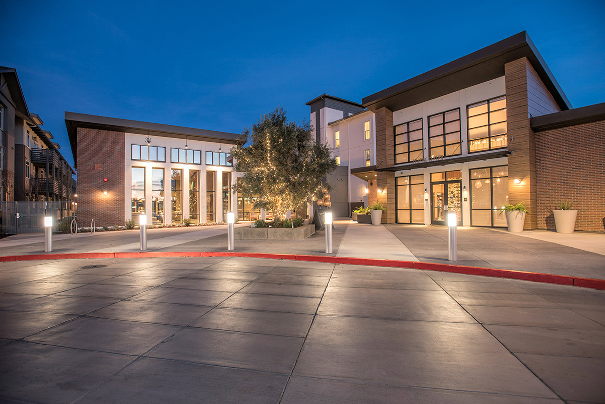 A driveway with lights, next to the entrance of the Vintage apartments in Pleasanton, CA