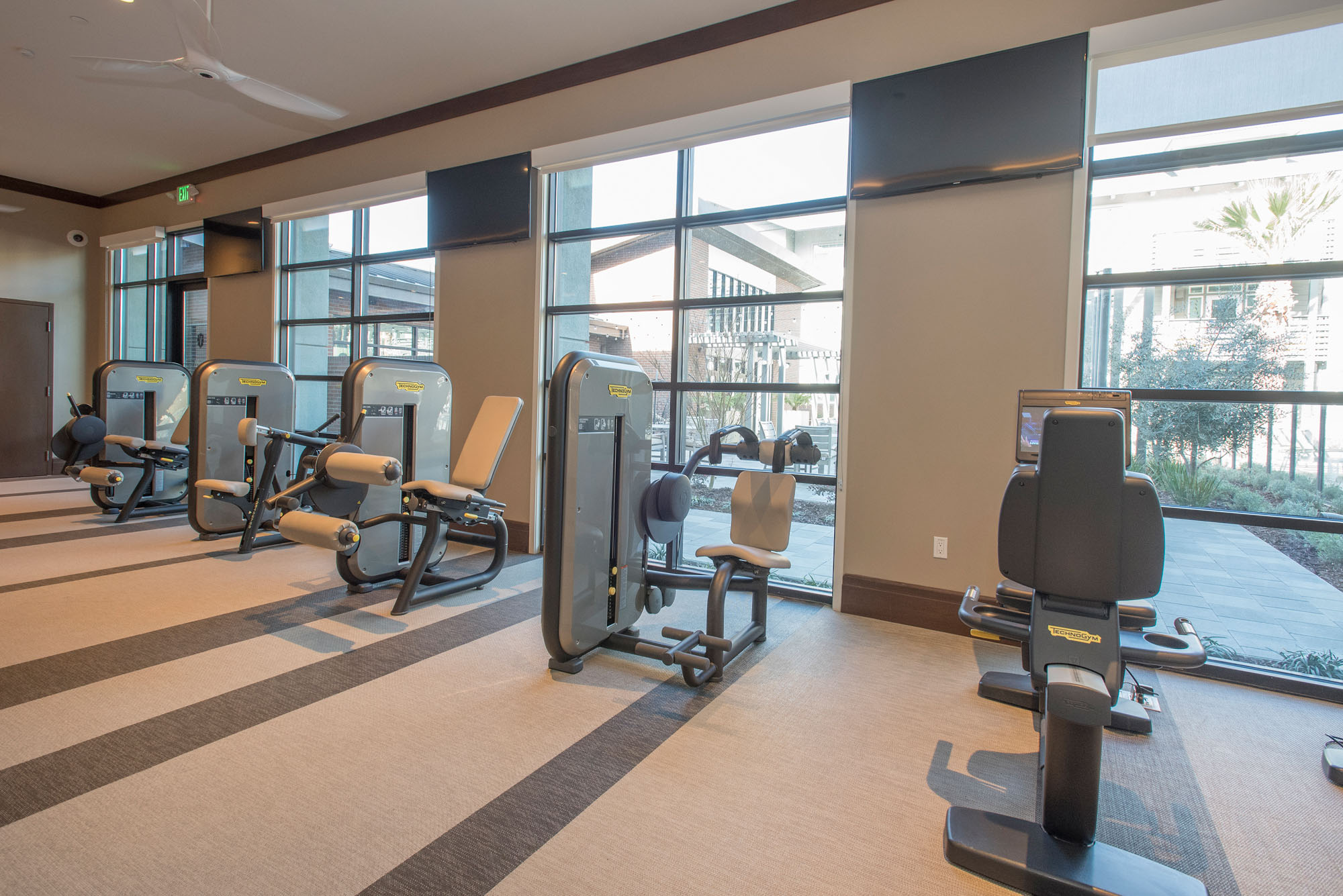 A fitness center with modern cable machines at the Vintage apartments in Pleasanton, CA