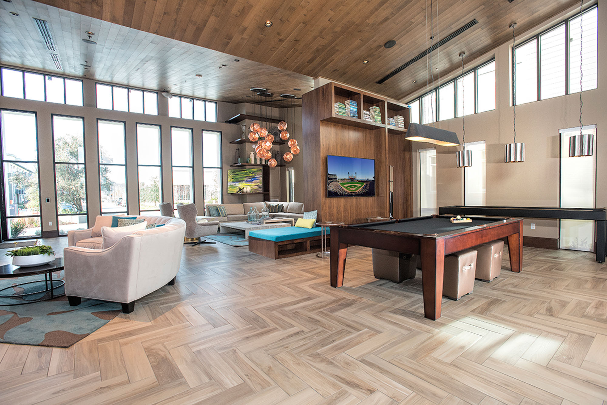 A pool table and shuffleboard in a spacious lounge in the clubhouse of the Vintage apartments in Pleasanton, CA