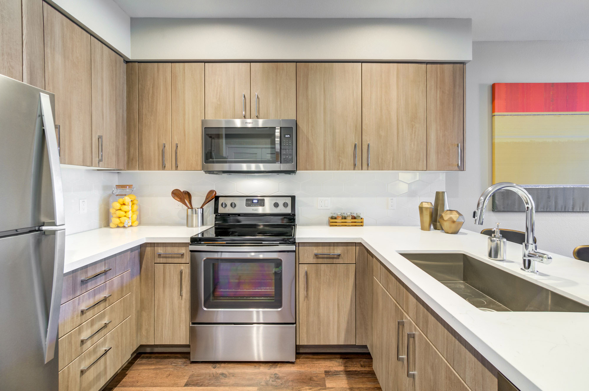 A U shaped kitchen with wood flooring at the Vintage luxury apartments in Pleasanton, CA