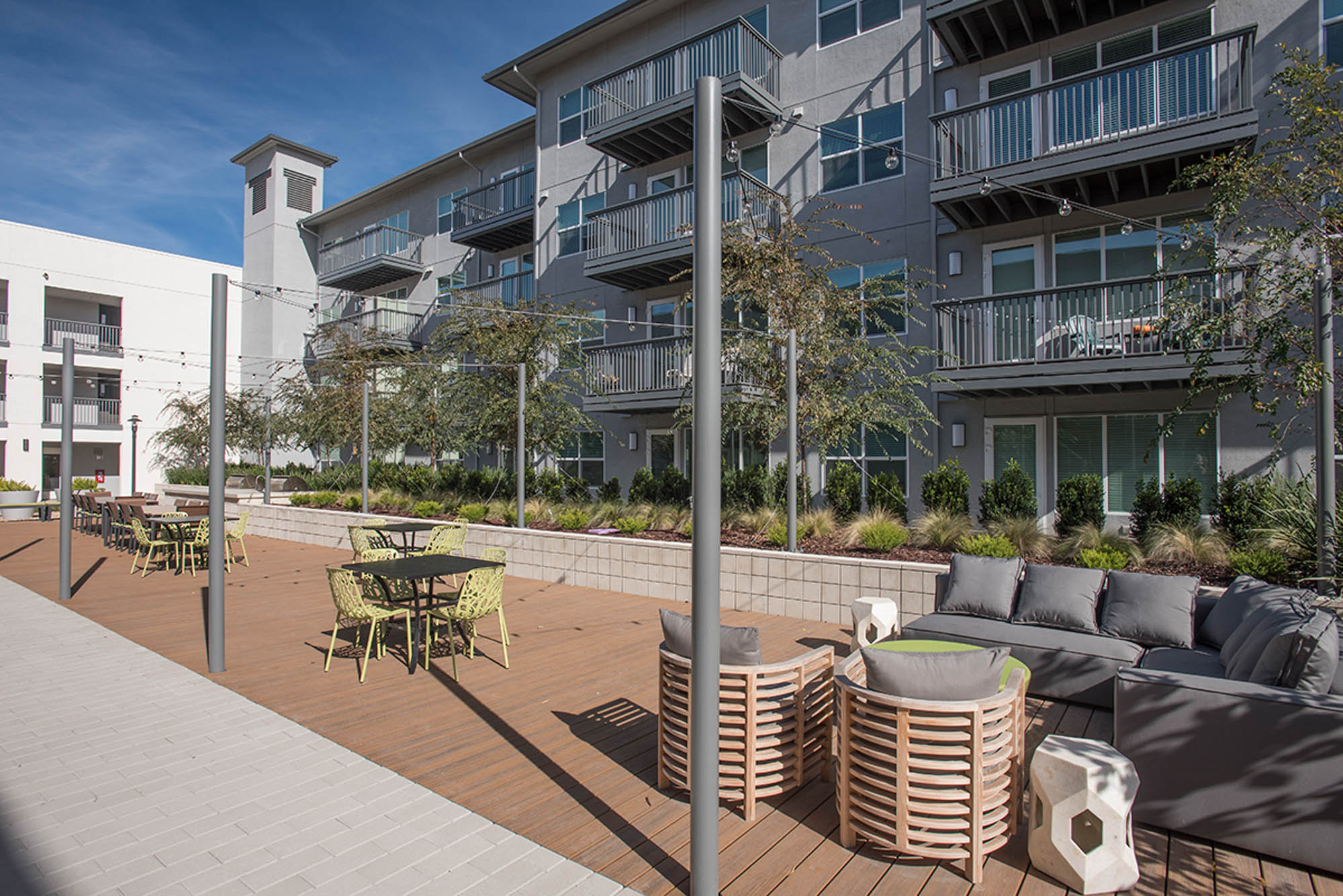 An outdoor lounging space with several dining tables at the Vintage apartments in Pleasanton, CA