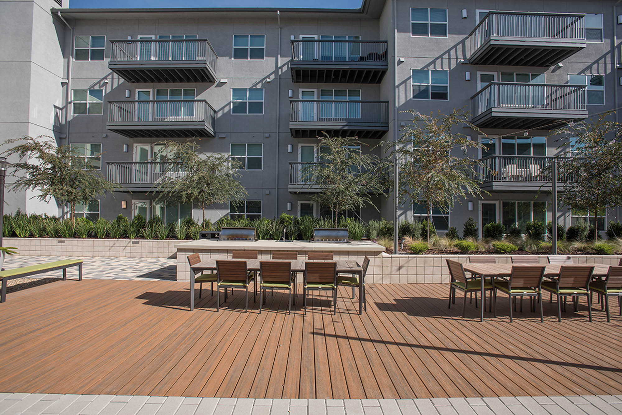 An outdoor lounging area with several dining tables at the Vintage apartments in Pleasanton, CA