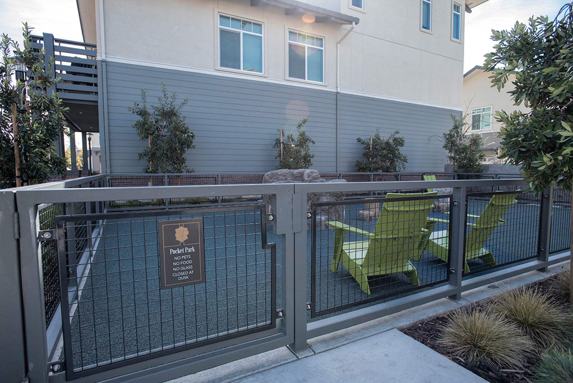 A gated playpen with a fake rock in the middle at the Vintage apartments in Pleasanton, CA