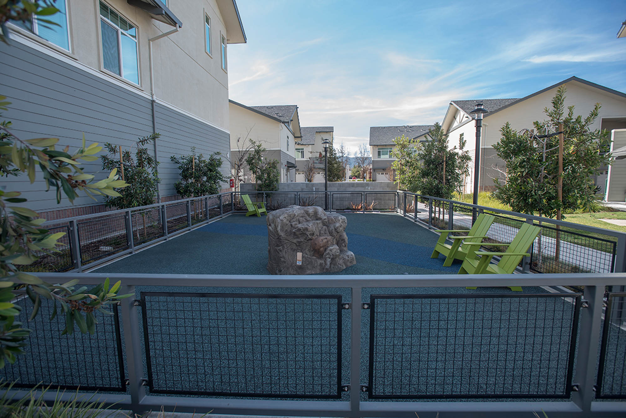 A gated playpen with a fake rock in the middle at the Vintage apartments in Pleasanton, CA