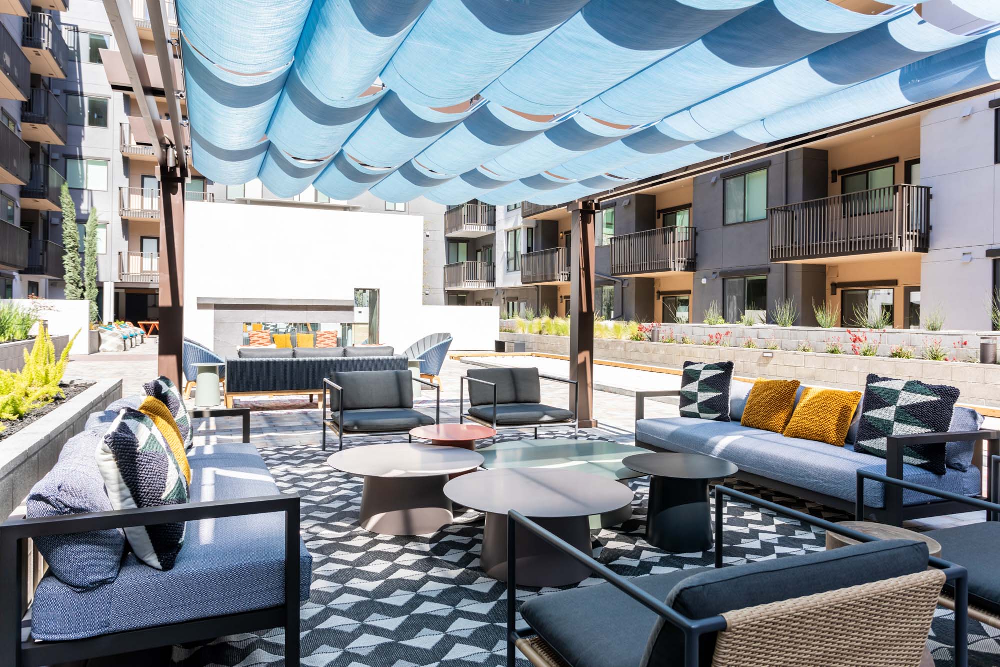 An outdoor shaded lounge area in the courtyard of the Webster Eleven apartments in downtown Oakland