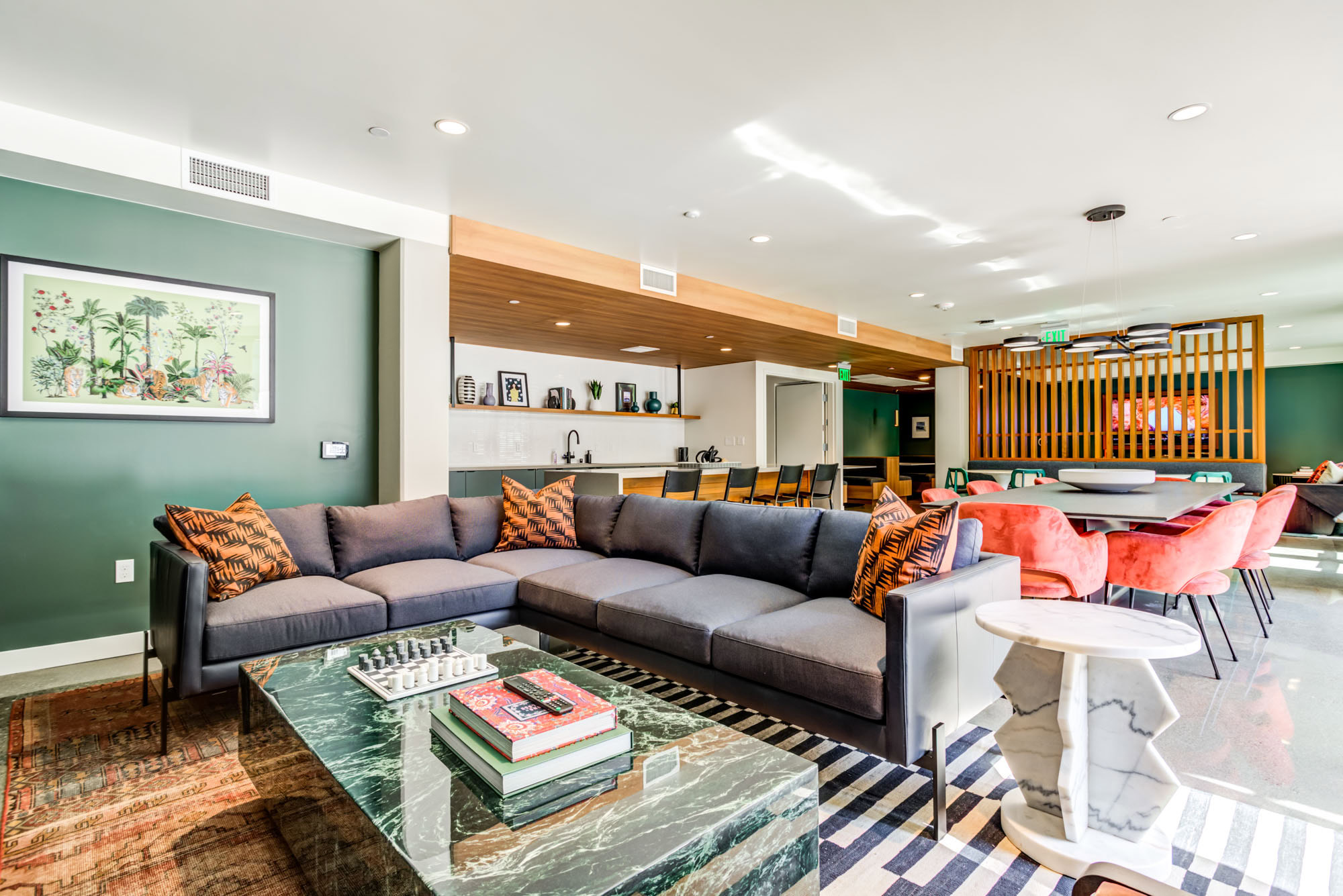 A lounge with dining tables and kitchen area at the Webster Eleven apartments in downtown Oakland