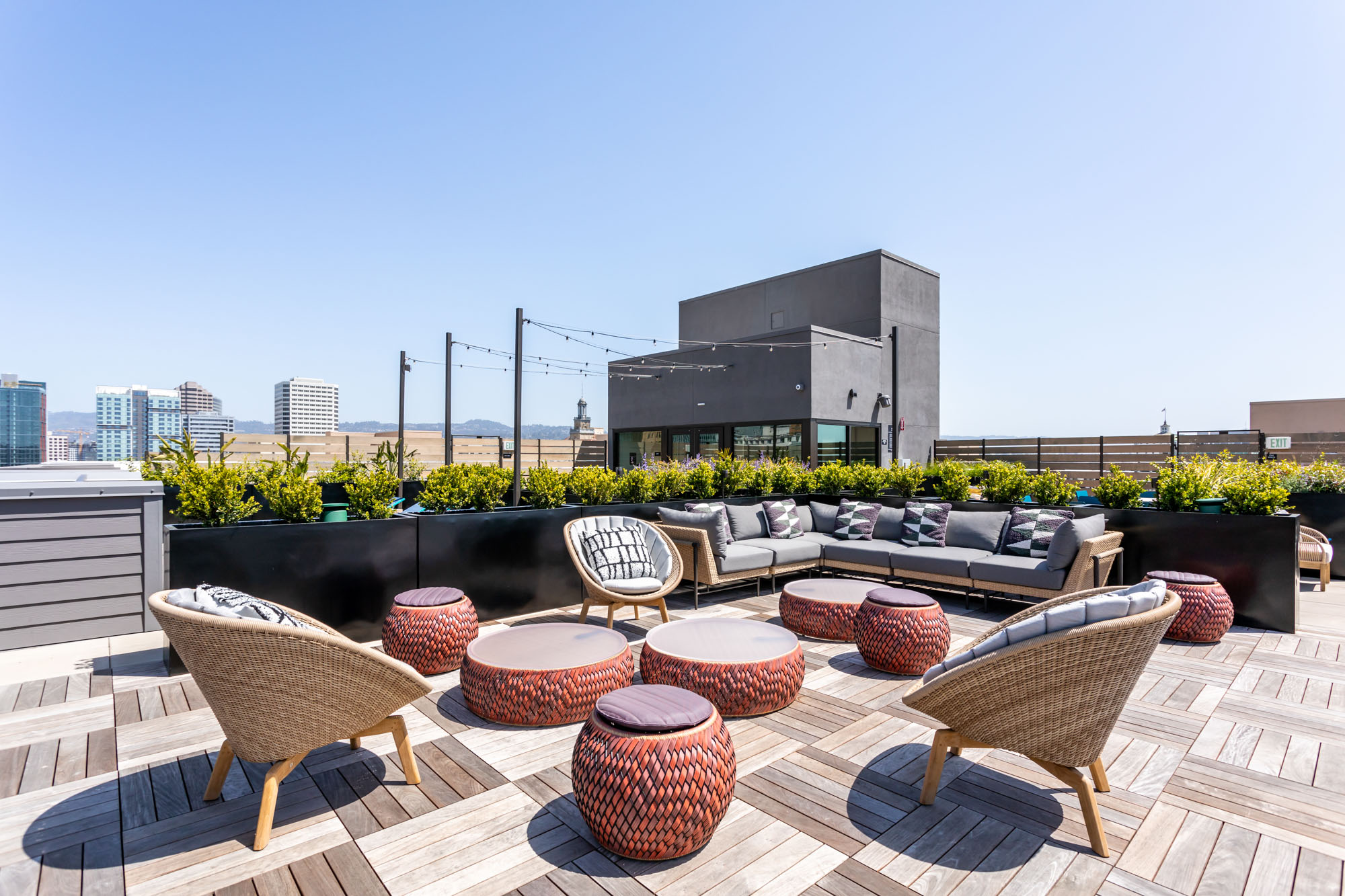 A rooftop lounge with wooden deck flooring at the Webster Eleven apartments in downtown Oakland