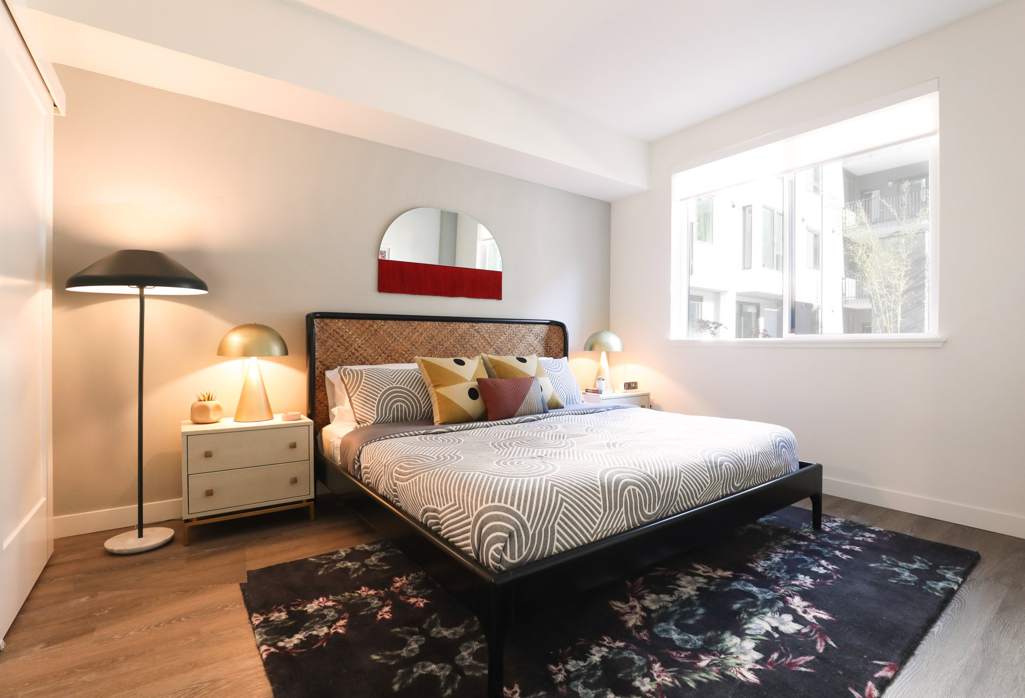 A bedroom with hardwood floors and windows at the Webster Eleven downtown Oakland apartments for rent