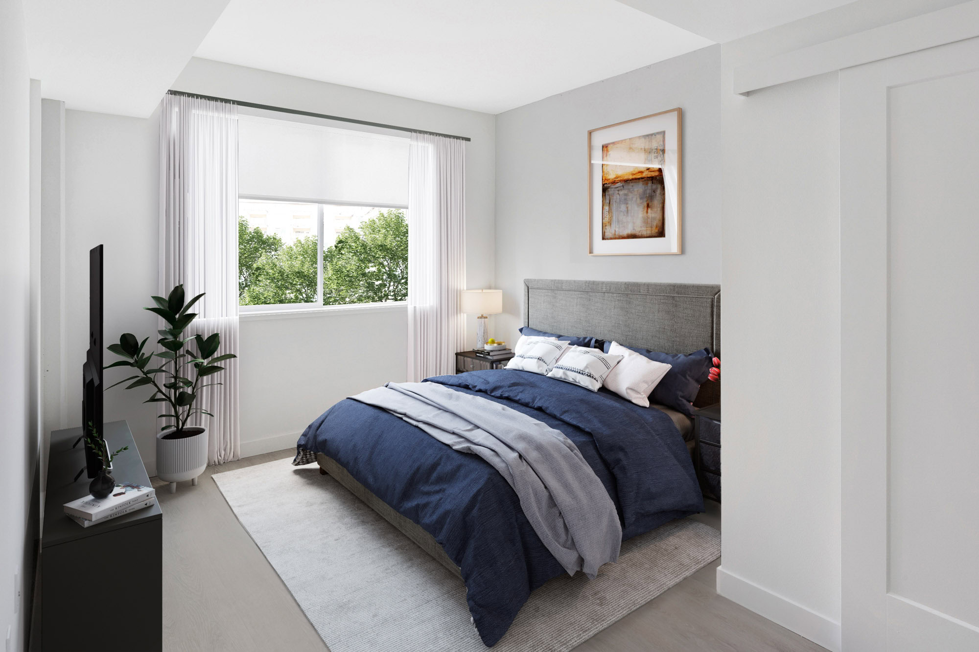 A bedroom with hardwood floors and windows at the Webster Eleven downtown Oakland apartments for rent