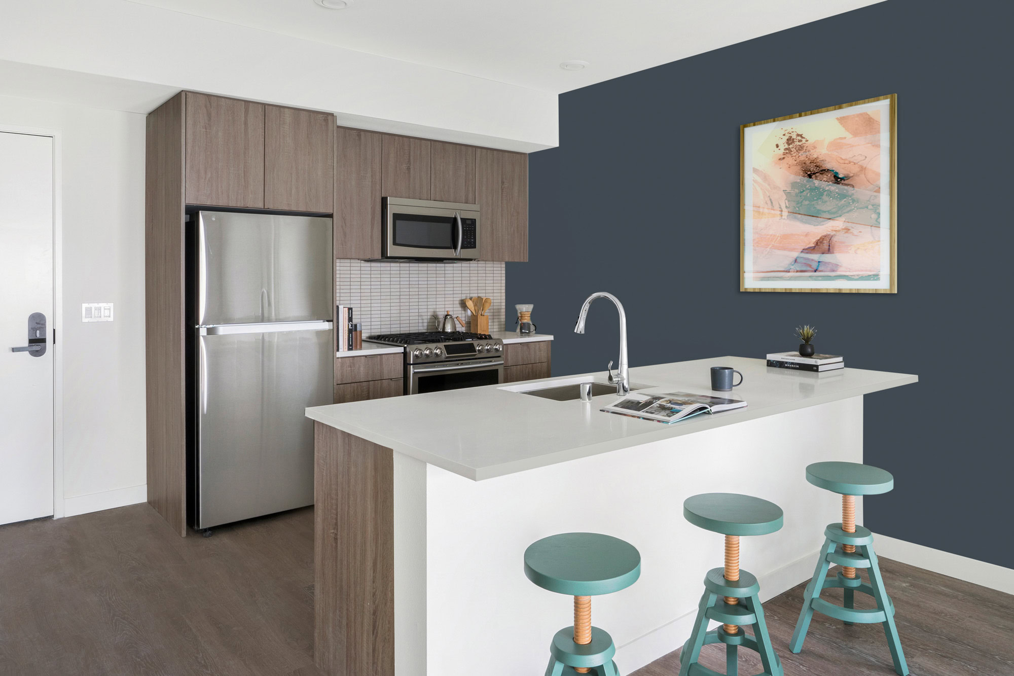 A kitchen with a kitchen island at the Webster Elevens downtown Oakland apartments for rent