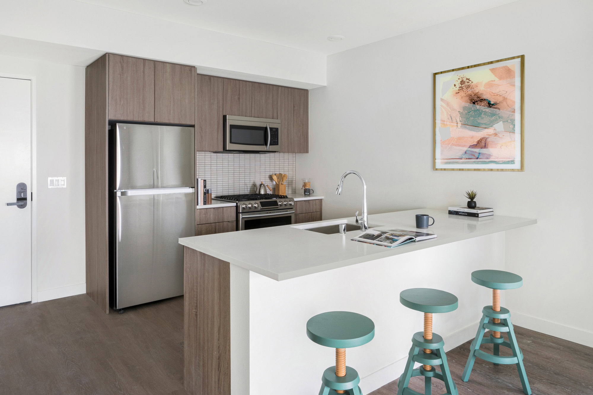 A kitchen with a kitchen island at the Webster Elevens downtown Oakland apartments for rent