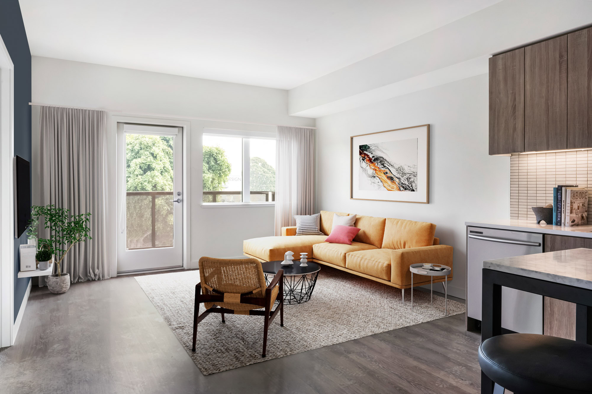 An open plan living room with a door to the balcony at a Webster Eleven apartment in downtown Oakland