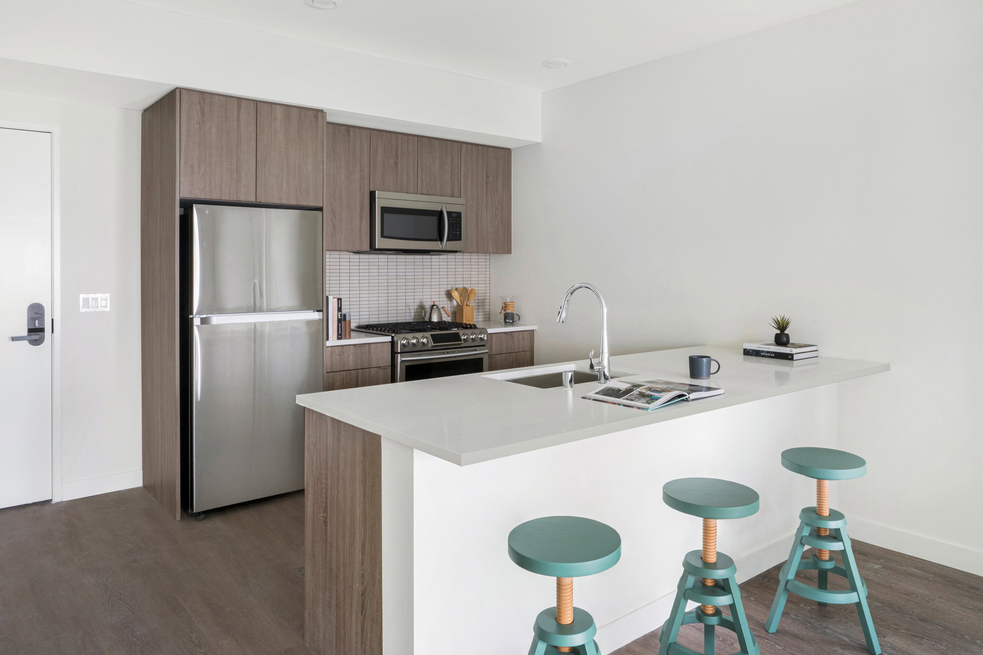 A kitchen with a kitchen island at the Webster Elevens downtown Oakland apartments for rent