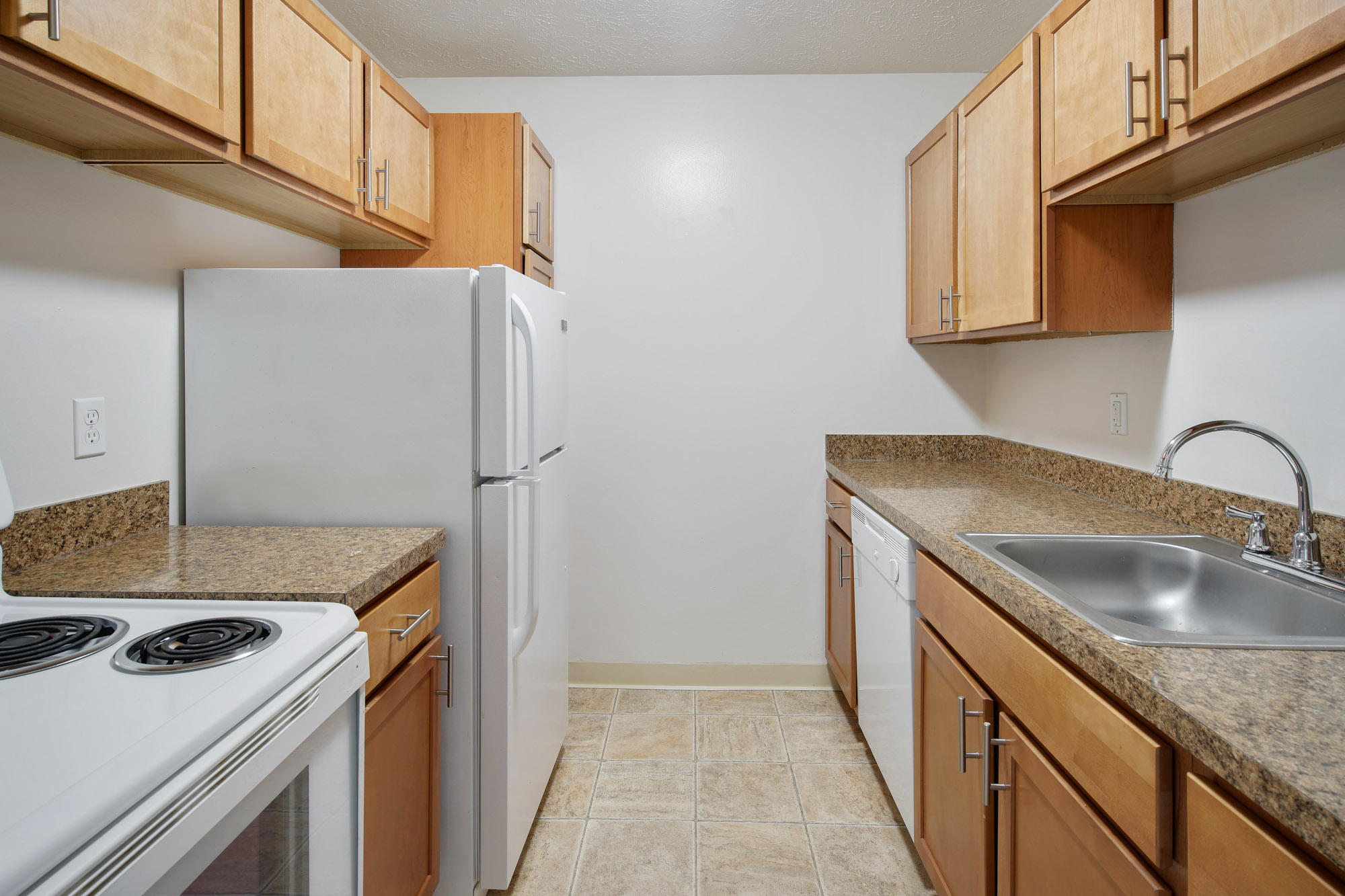 Galley kitchen with ample counter space and storage.