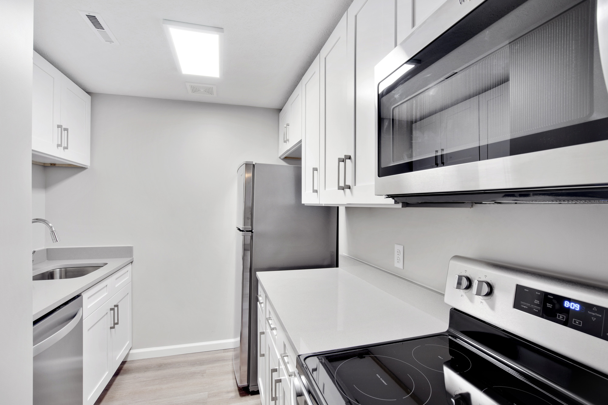 Galley kitchen with ample counter space and storage. Renovated units offer stainless steel appliances and deep farmhouse sinks.