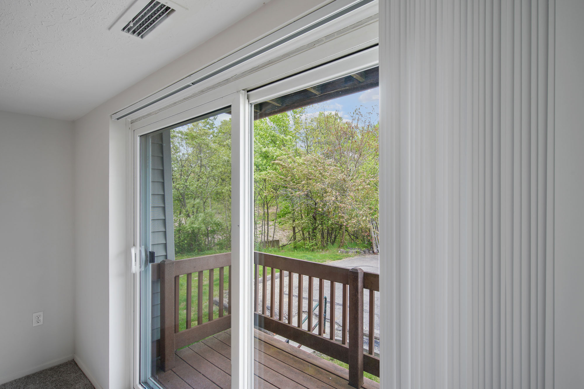 Image depicts a second floor balcony off of a living room.