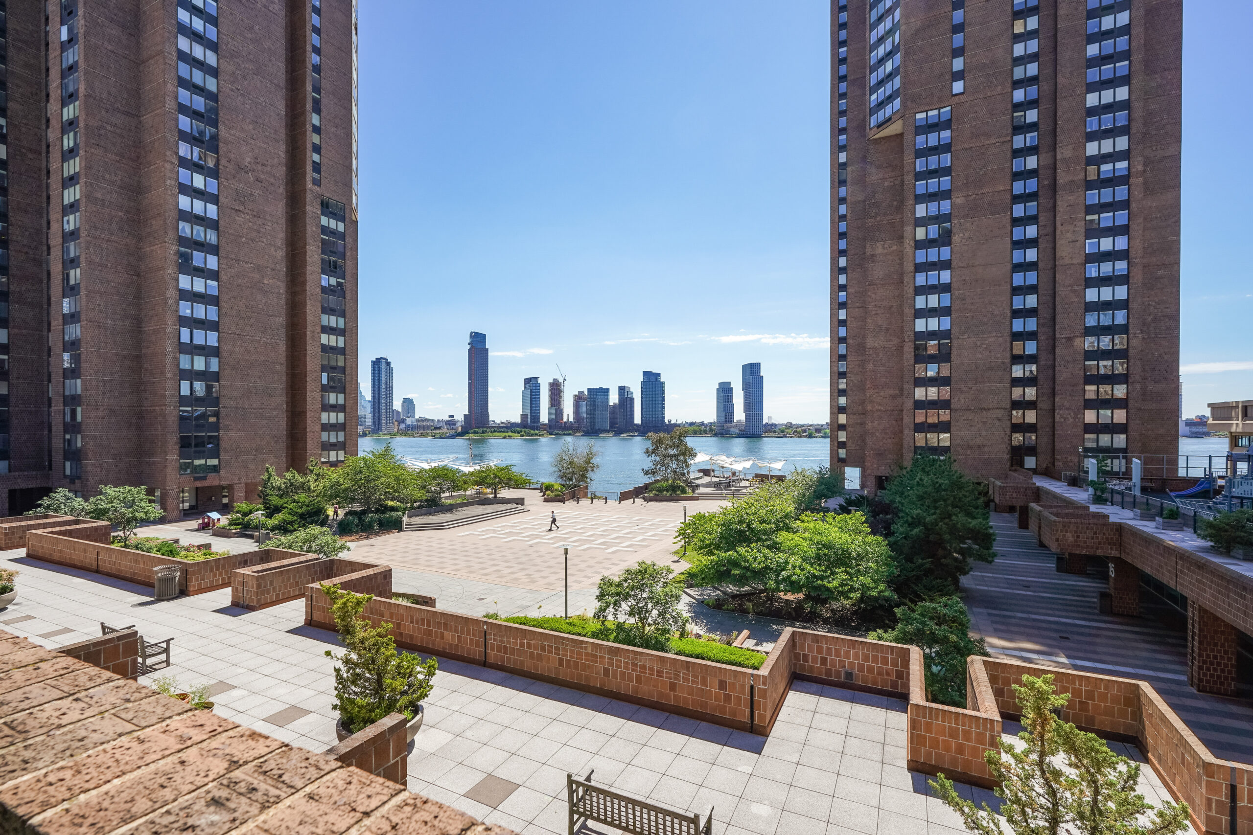 View looking across the plaza at Waterside with the East river in the background.