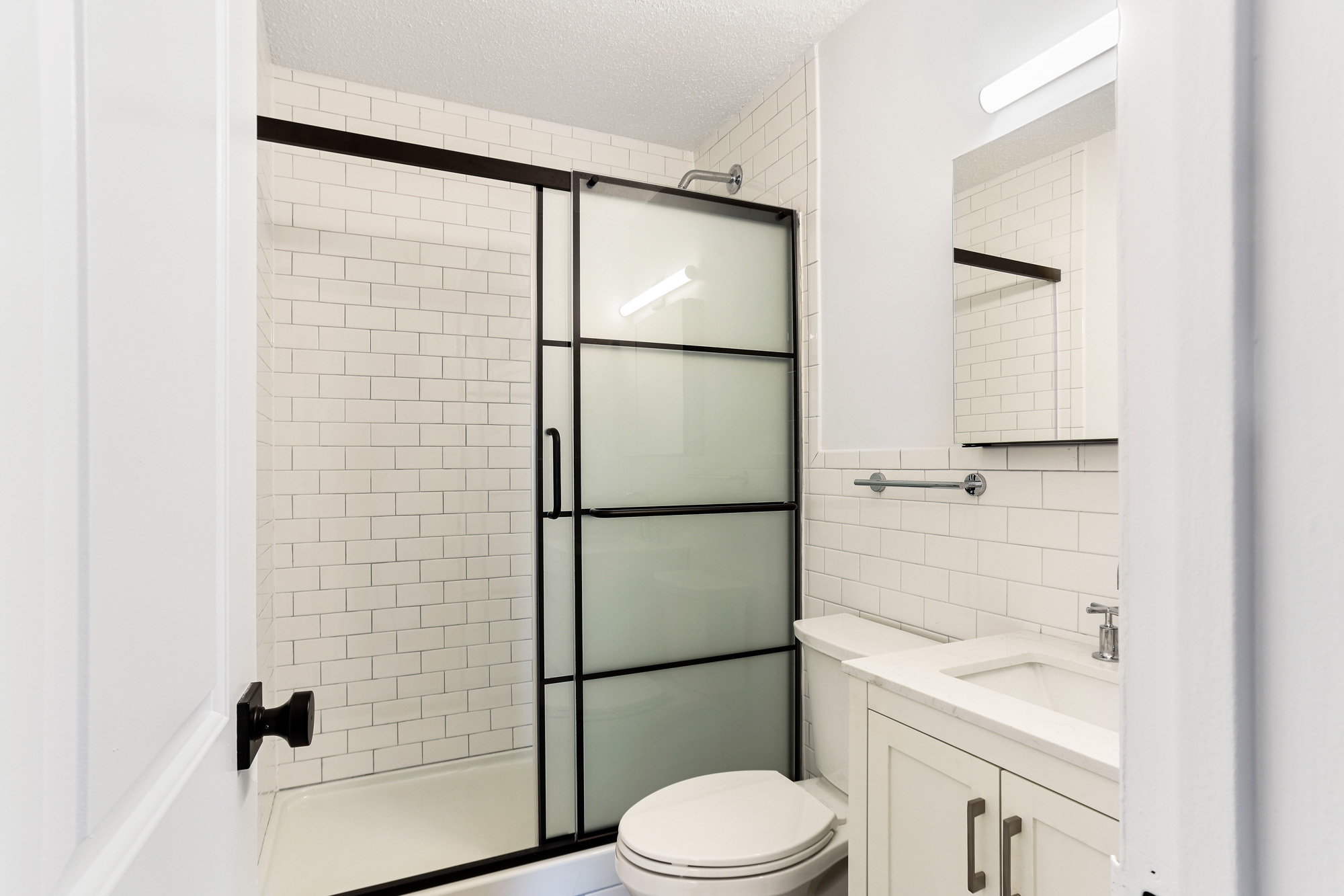 Spa like bathroom with subway tile and sizable vanity.