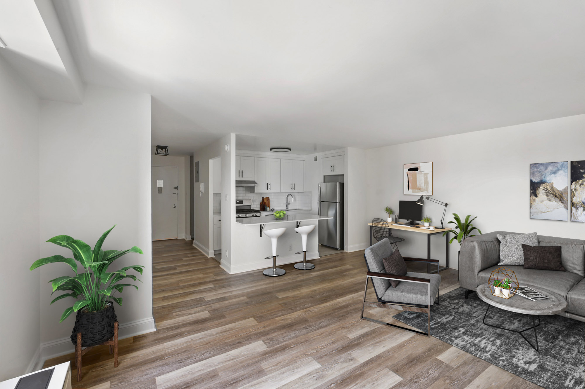 Corner kitchenette at Waterside Plaza with stainless steel appliances and deep farmhouse sink.