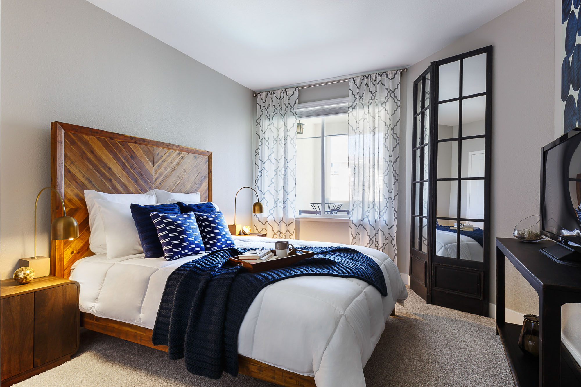 A cozy bedroom with carpet flooring at Alders luxury apartments in Northridge, Los Angeles