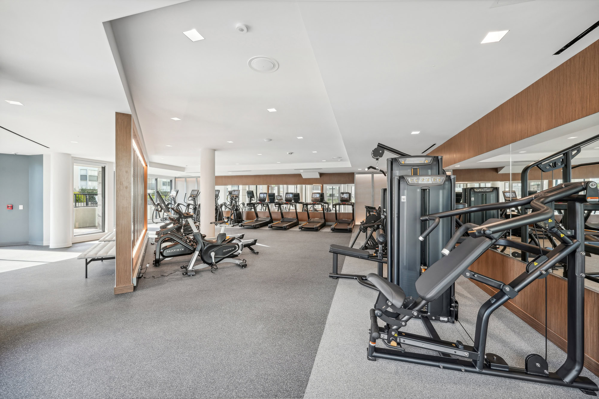 A fully equipped modern fitness center at Bayside Village apartments in San Francisco