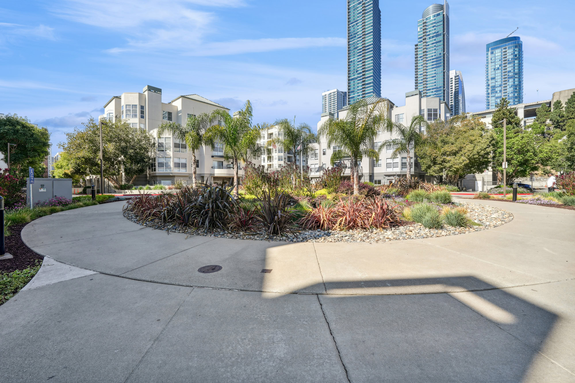 A walk path roundabout with succulents and greenery in the middle at Bayside Village in San Francisco
