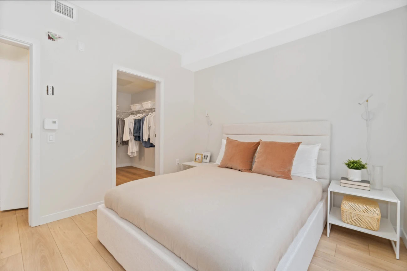 A bedroom with spacious a walk in closet at the Hendry Place luxury apartments in Vancouver