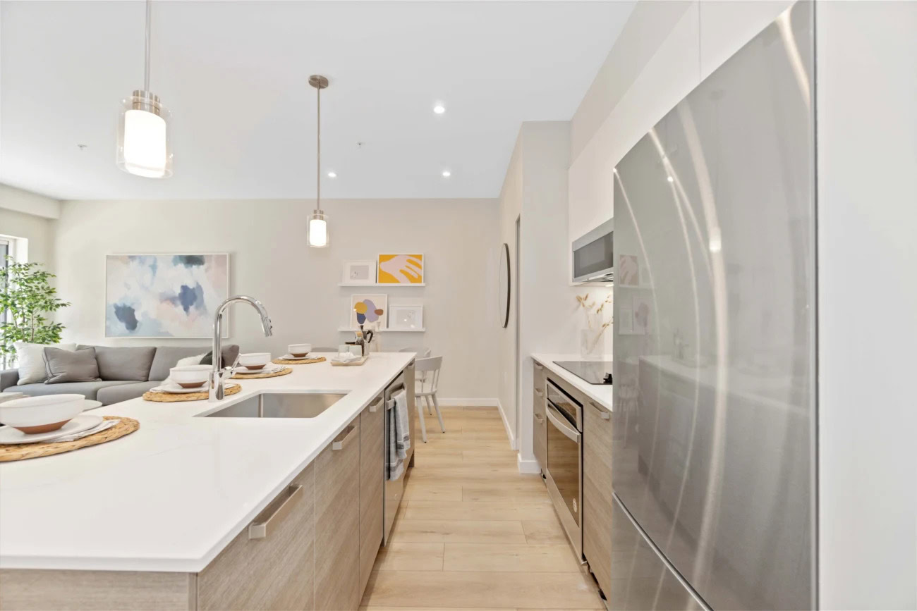 An open kitchen, kitchen island and stainless steel appliances at the Hendry Place luxury apartments in Vancouver