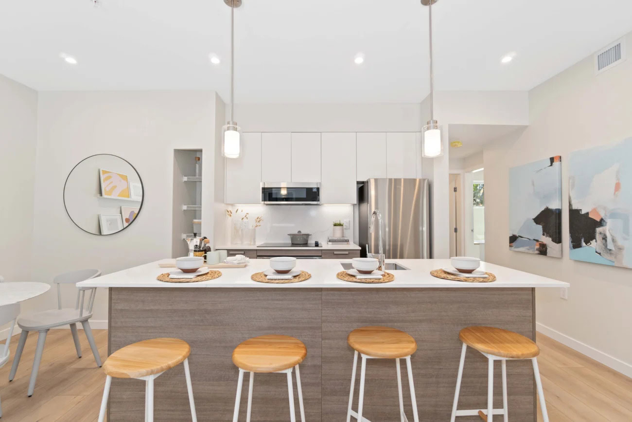 An open kitchen, kitchen island and stainless steel appliances at the Hendry Place luxury apartments in Vancouver