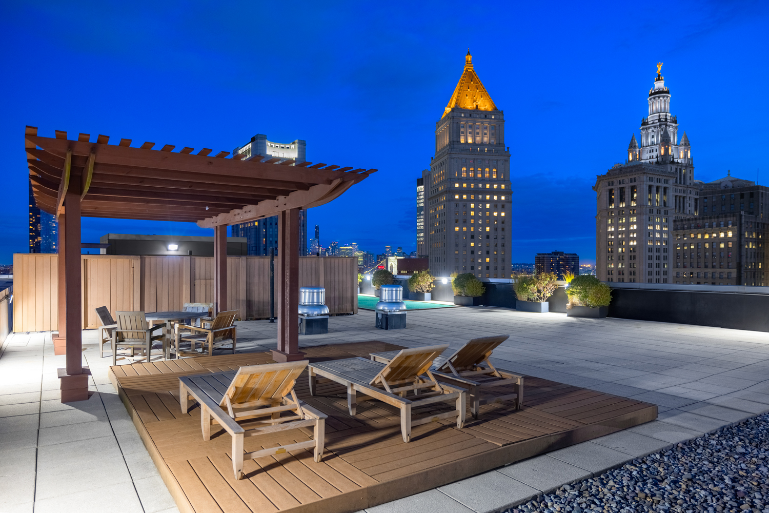 Sky Deck with panoramic vistas and lounge chairs at night.