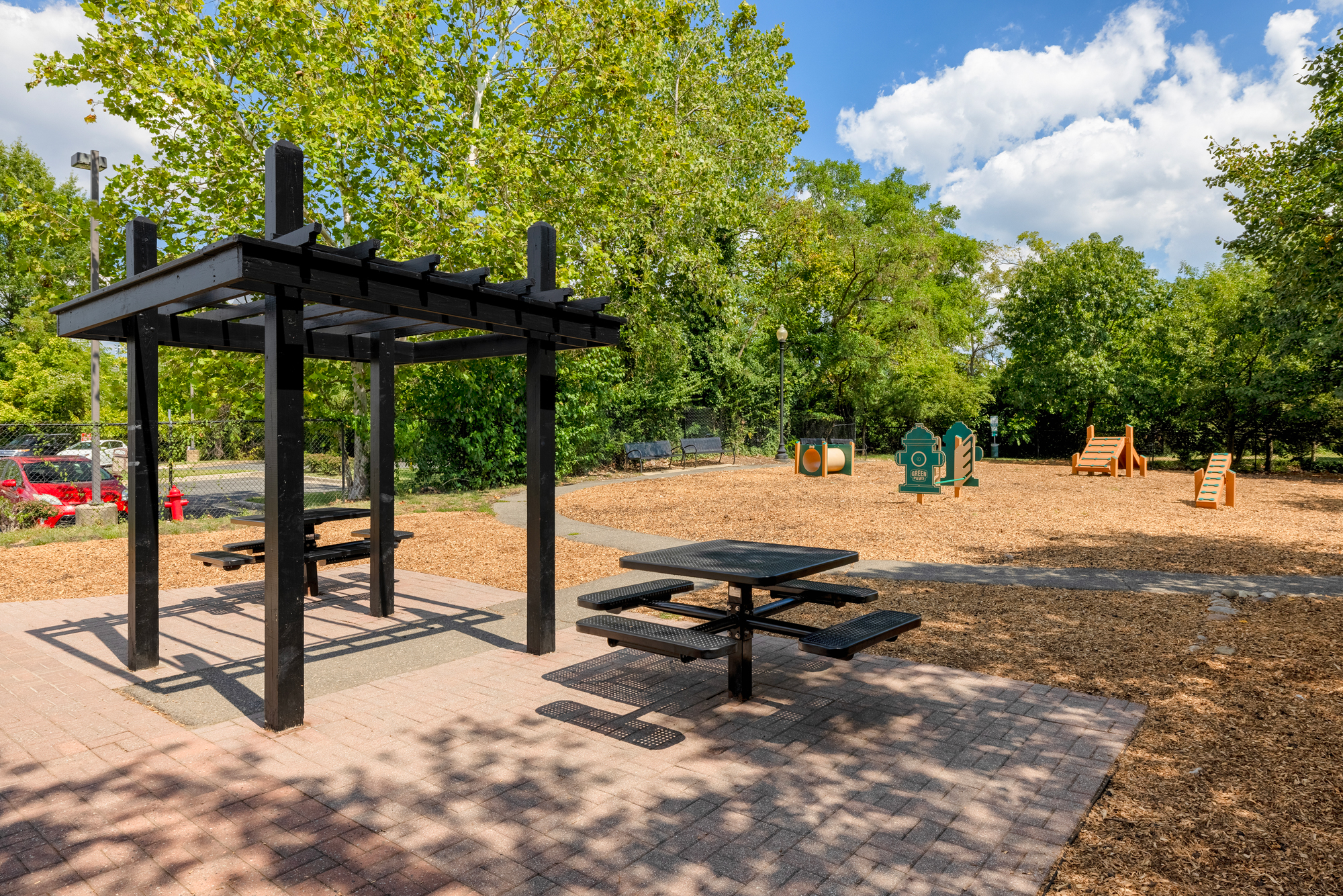 Spacious fenced dog park with equipment.