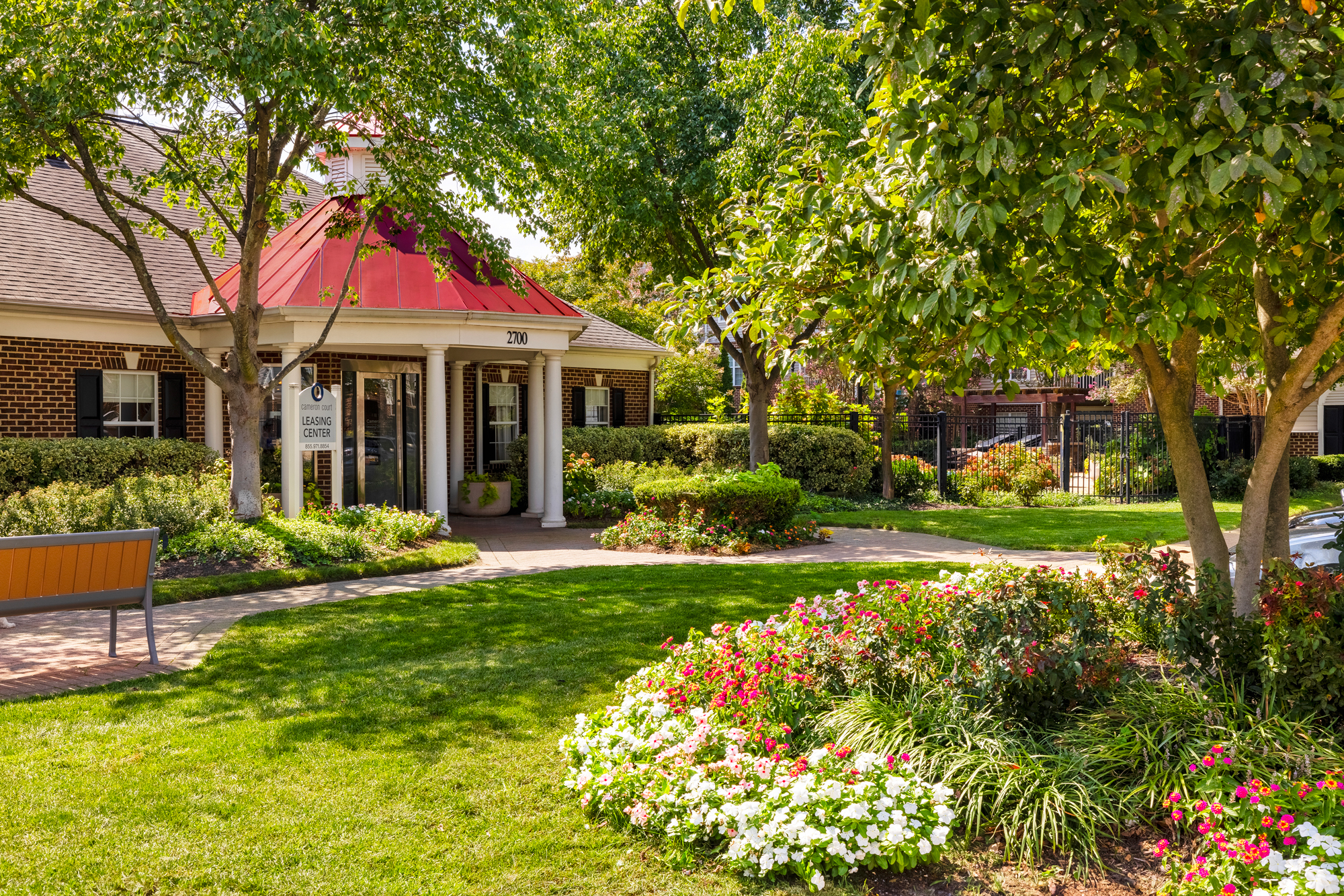 The leasing center and clubhouse at Cameron Court surrounded by lush landscaping.