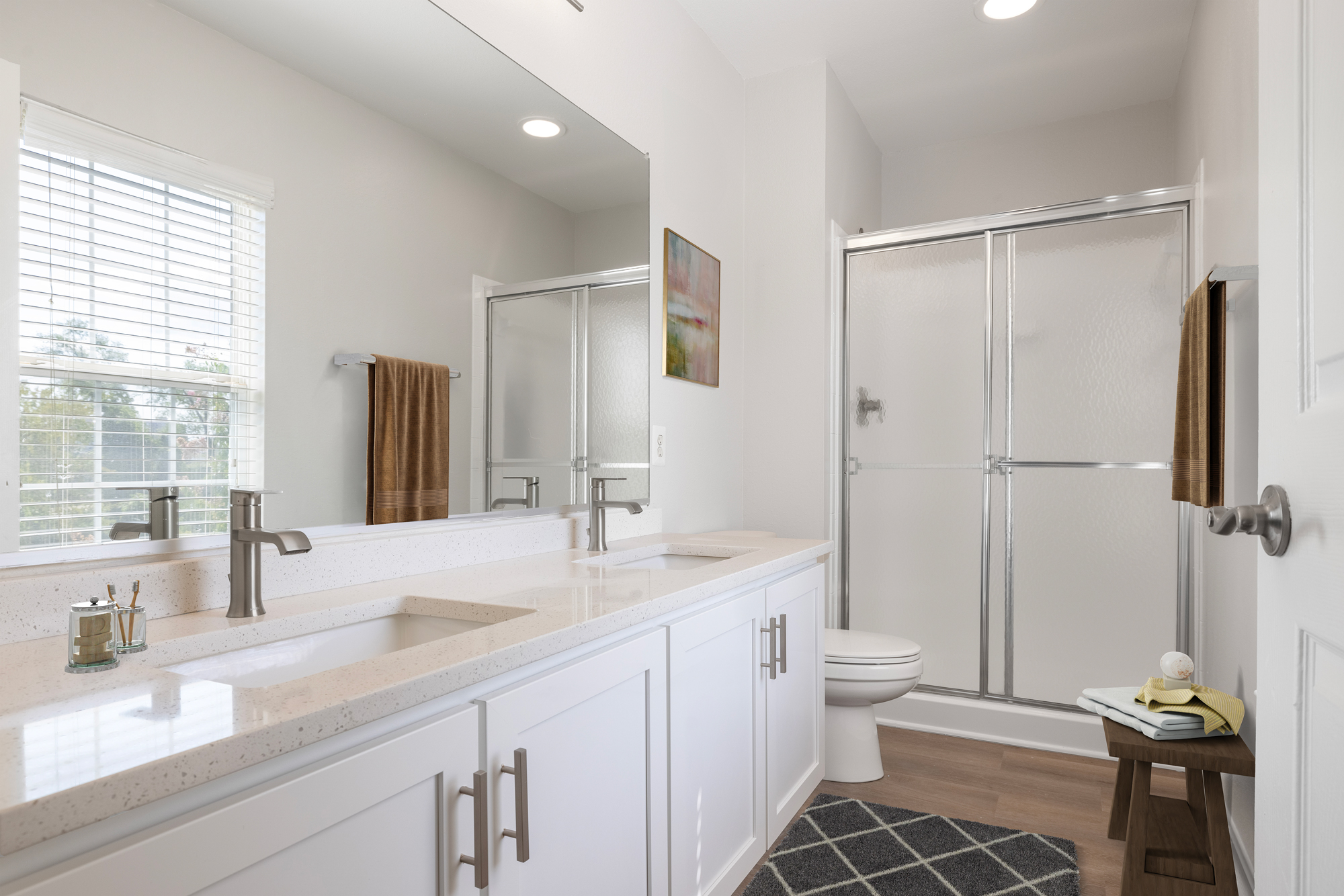 Sleek bath with glass-enclosed shower area and decor.