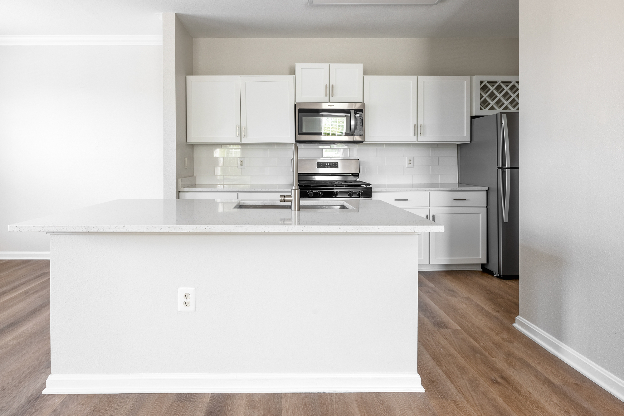 Townhome kitchen with shaker-style cabinetry and quartz countertops.