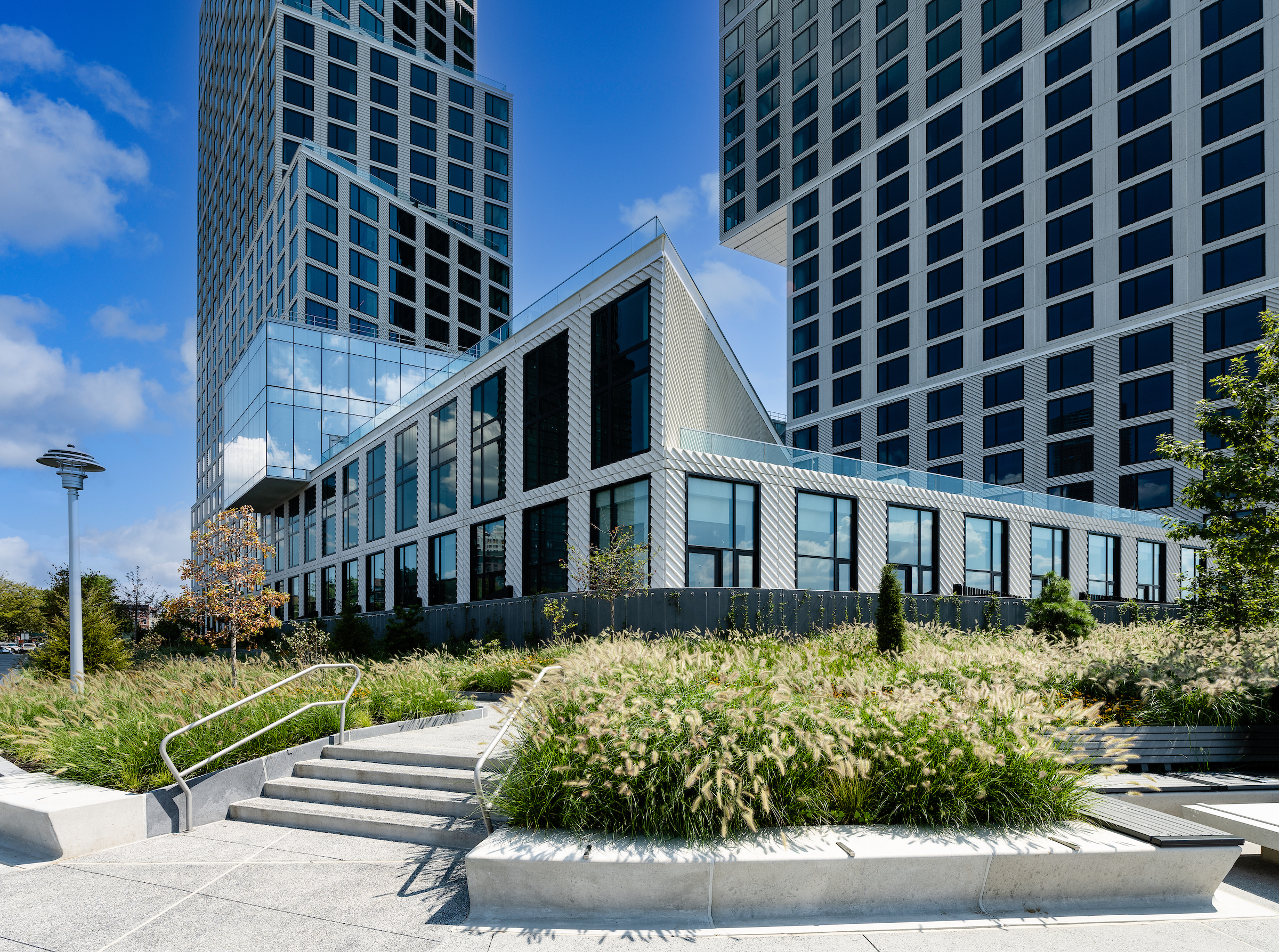 The exterior of Eagle + West at daytime showing all three buildings.