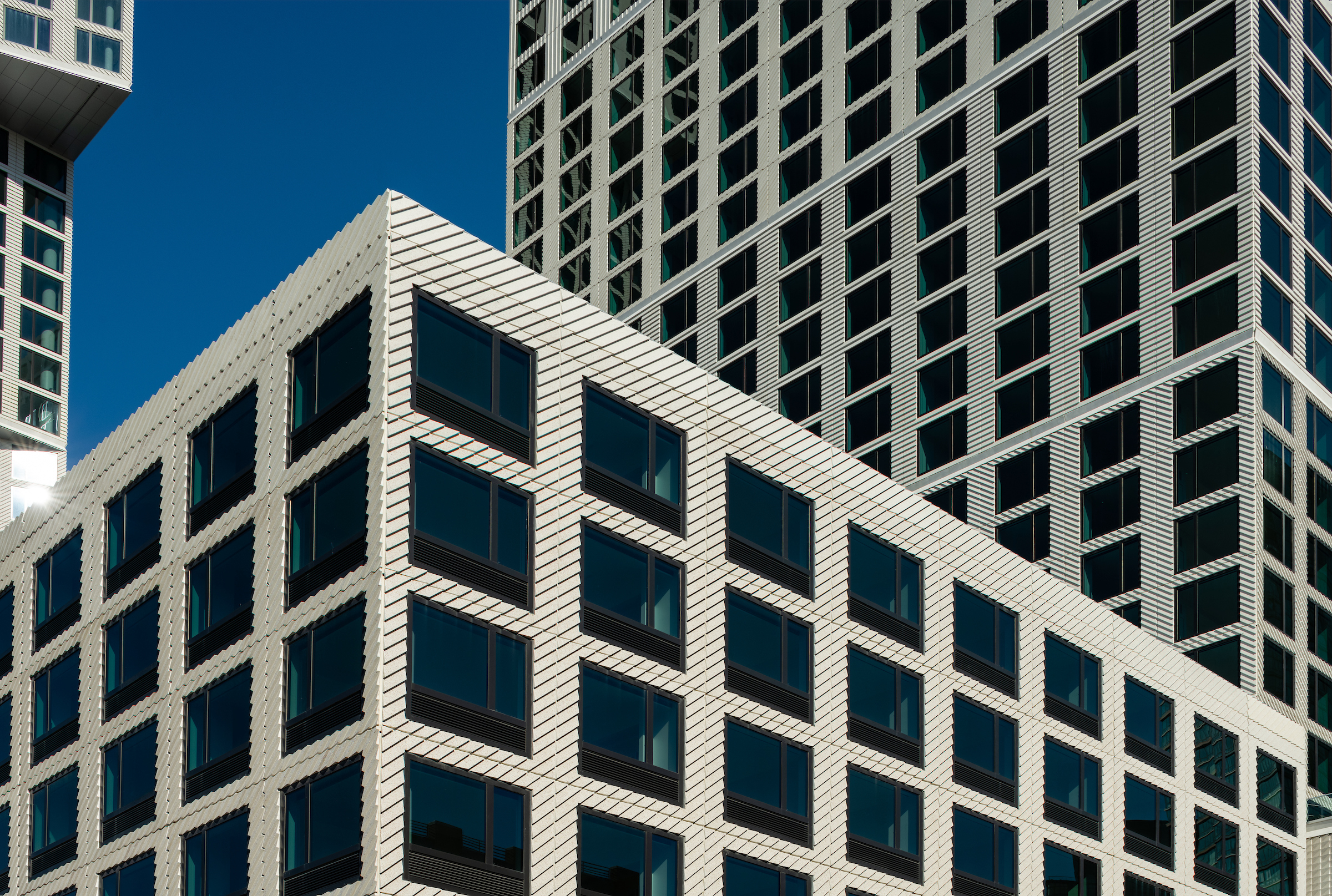 The exterior of Eagle + West at daytime showing all three buildings.