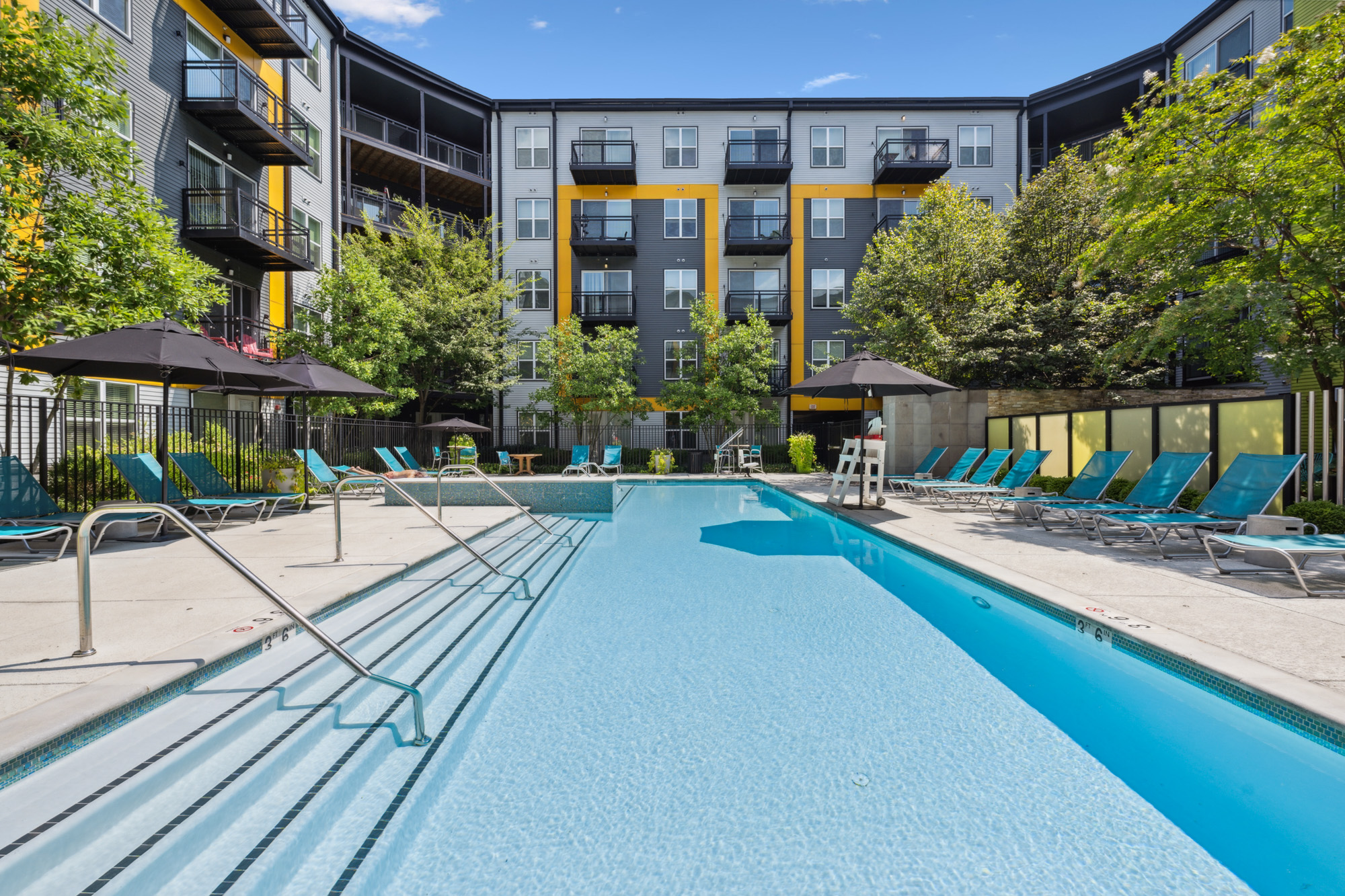 Pool and deck with lounge seating.