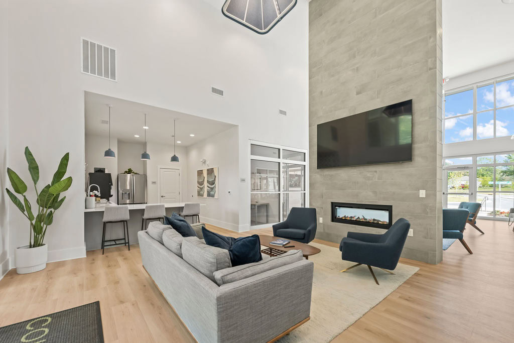 A lobby lounge featuring a private work room, and a kitchen area at the Courtney Ridge apartments in Charlotte, NC