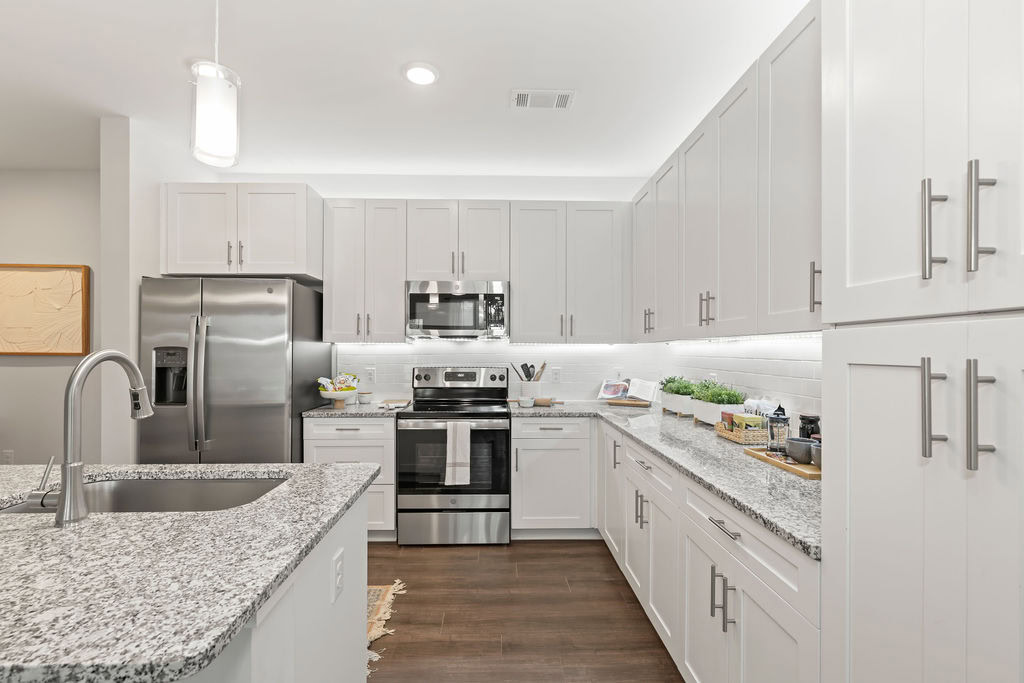 A kitchen with a kitchen island in an apartment at the Courtney Ridge apartments in Charlotte, NC
