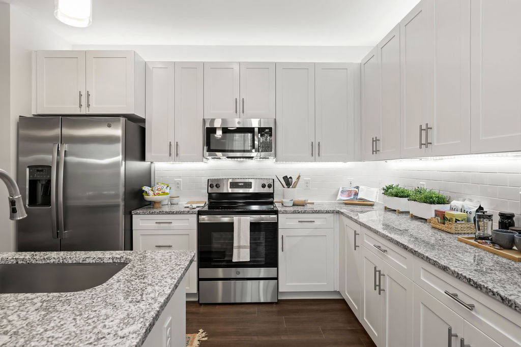 A kitchen with a kitchen island in an apartment at the Courtney Ridge apartments in Charlotte, NC